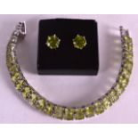 A SILVER AND PERIDOT DOUBLE LINE BRACELET with matching earrings. (2)