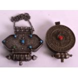 AN EARLY 20TH CENTURY TIBETAN SILVER PENDANT inset with coral, together with another similar