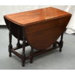 AN OAK DROP LEAF TABLE. 4Ft 11ins wide.