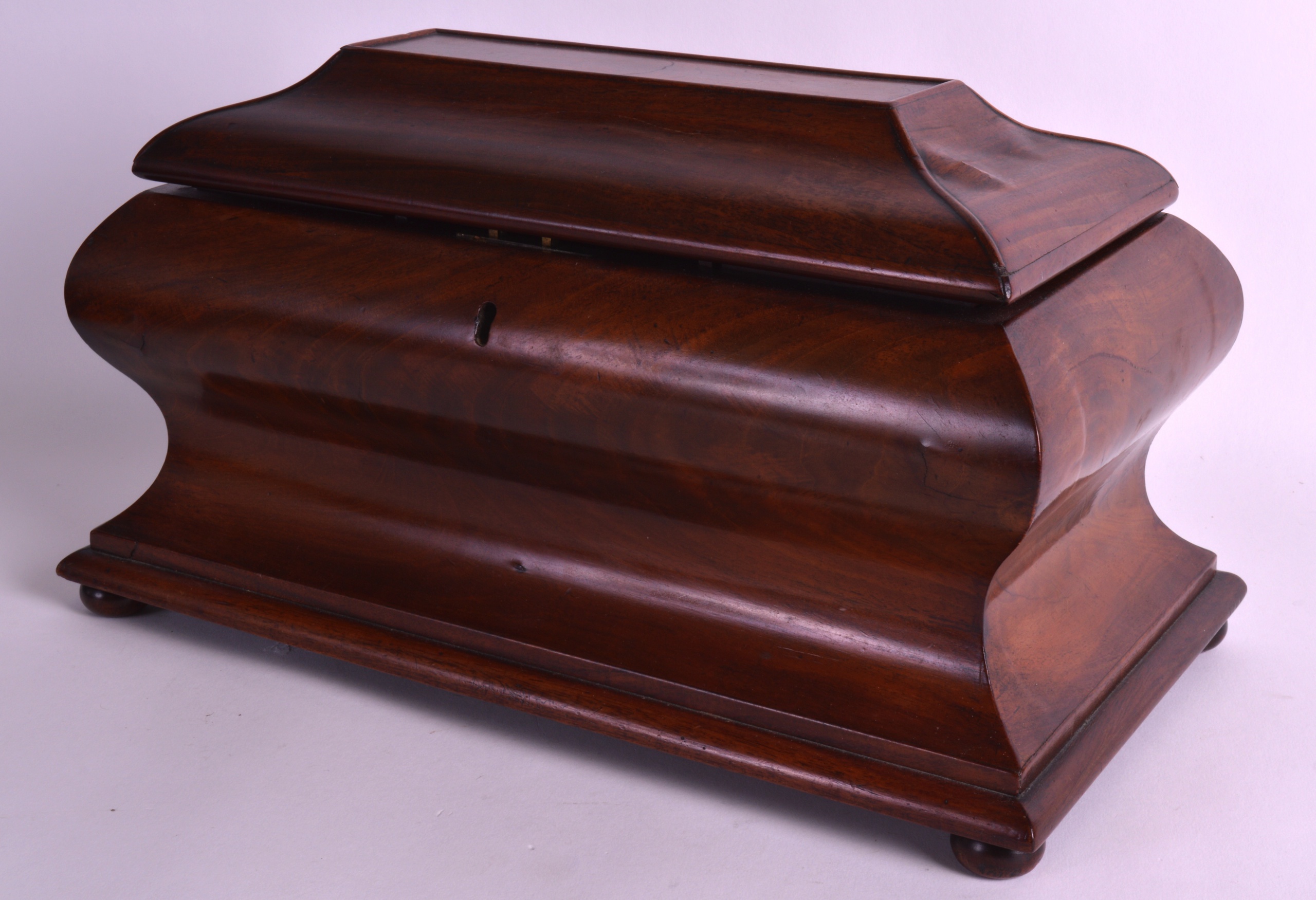 A LARGE MID VICTORIAN CARVED MAHOGANY SARCOPHAGUS SHAPED TEA CADDY with two removable covers,