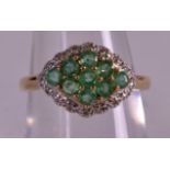 A 9CT GOLD EMERALD AND DIAMOND RING.