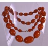 A FINE EARLY 20TH CENTURY CARVED AMBER TYPE NECKLACE of graduated form. 78 grams. 2Ft 4ins