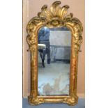 A LATE 18TH/19TH CENTURY ITALIAN CARVED GILTWOOD MIRROR with original silvered glass. 3Ft high.