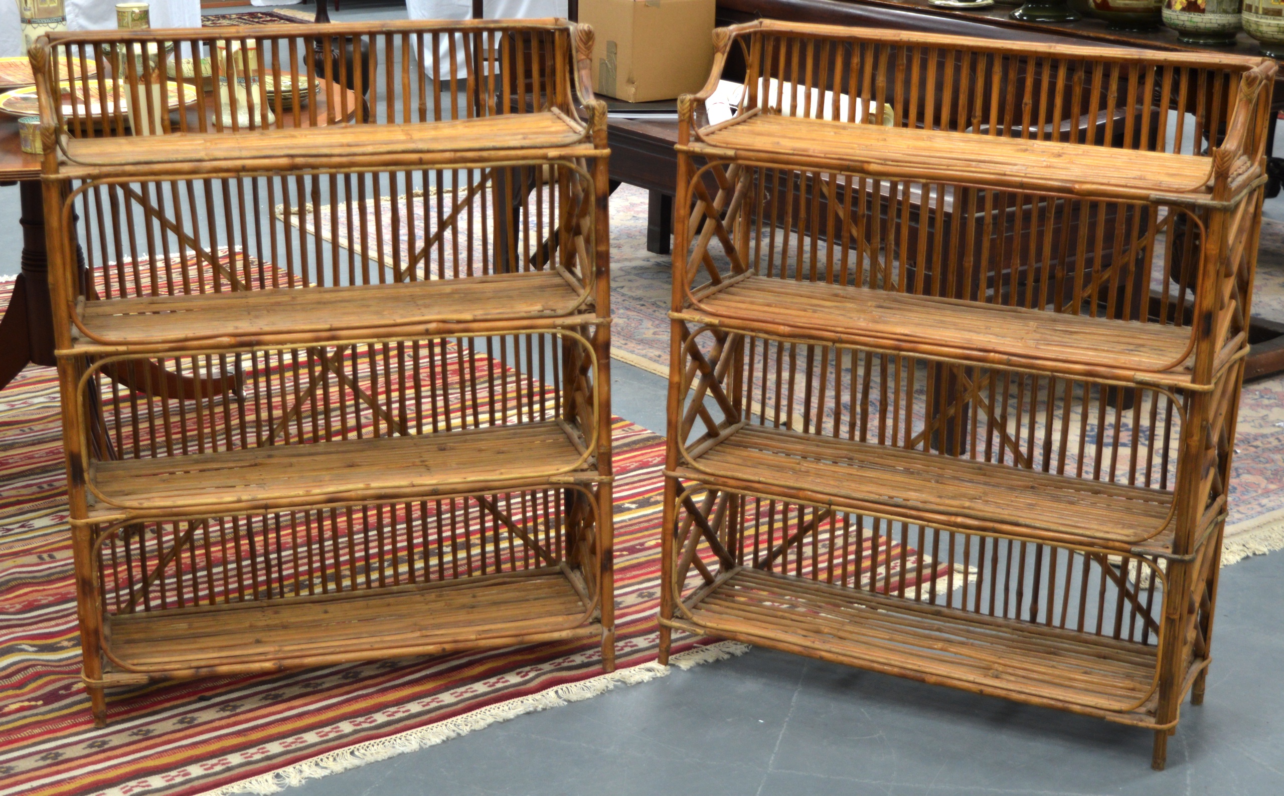 A PAIR OF STYLISH EARLY 20TH CENTURY BAMBOO OPEN BOOKCASES with angular carved fretwork.