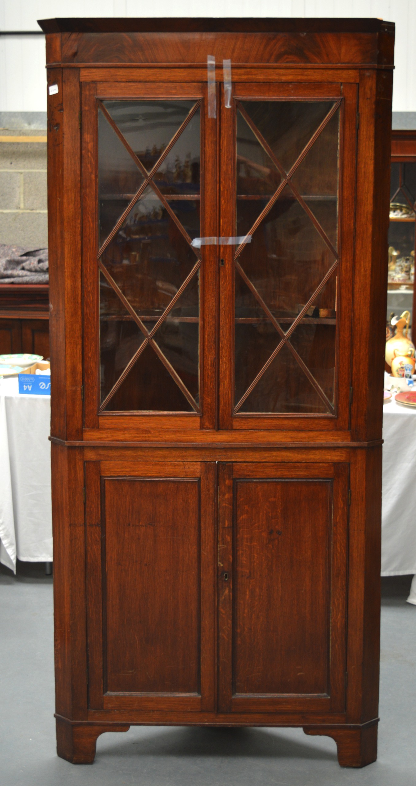 A LARGE ANTIQUE OAK CORNER CABINET with glass fronted doors. 6Ft 8ins x 3ft 2ins.