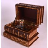 AN UNUSUAL EARLY 20TH CENTURY LEATHER GENTLEMANS DECANTER SET formed as a stack of books. 7Ins