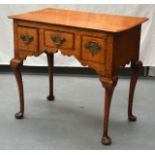 AN 18TH CENTURY OAK LOW BOY with brass handles and three drawers. 2Ft 7ins wide.