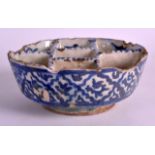 A 17TH CENTURY PERSIAN BLUE AND WHITE MULTI SECTION BOWL painted with stylised flowers. 6Ins