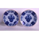 A PAIR OF 18TH CENTURY DUTCH BLUE AND WHITE DELFT DISHES painted with vases of flowers. 9.25ins