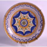 AN 18TH CENTURY EUROPEAN TIN GLAZED DISH painted with stylised yellow and blue motifs. 12Ins