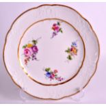 AN 18TH CENTURY SEVRES PORCELAIN MOULDED PLATE C1770 painted with flowers and a gilt border. 9.25ins