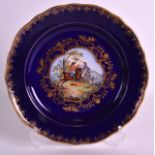 A 19TH CENTURY VIENNA STYLE PLATE painted with battle scenes within a blue border. 9.5ins diameter.