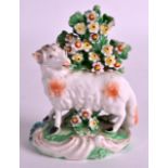 AN 18TH CENTURY DERBY PATCH MARK FIGURE OF A SHEEP modelled upon a painted base encrusted with