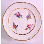 AN 18TH CENTURY SEVRES PORCELAIN MOULDED PLATE C1770 painted with flowers within a gilt border. 9.