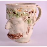 A LATE 18TH CENTURY CREAMWARE POTTERY MUG modelled in the form of bacchus. 4Ins high.