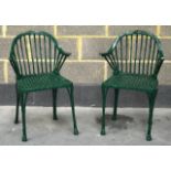 A PAIR OF VINTAGE GREEN PAINTED CAST IRON GARDEN CHAIRS.