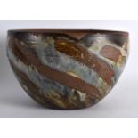 A VINTAGE STUDIO POTTERY STONEWARE BOWL with swirling decoration. 9Ins diameter.