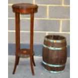 AN EDWARDIAN MAHOGANY POT STAND together with an oak brass bound bucket. (2)