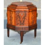 A FINE REGENCY FLAME MAHOGANY CELLARETTE with octagonal rising top, supported upon four well