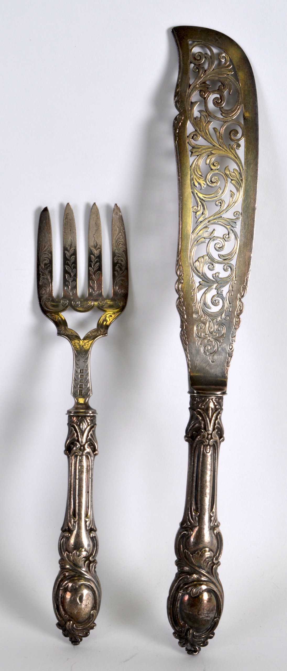 A PAIR OF VICTORIAN SILVER FISH SERVERS with silver blades, engraved all over with foliage.