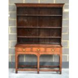 AN 18TH CENTURY COUNTRY OAK DRESSER with canted cornice, the base with three drawers. 4Ft 6ins x 6ft