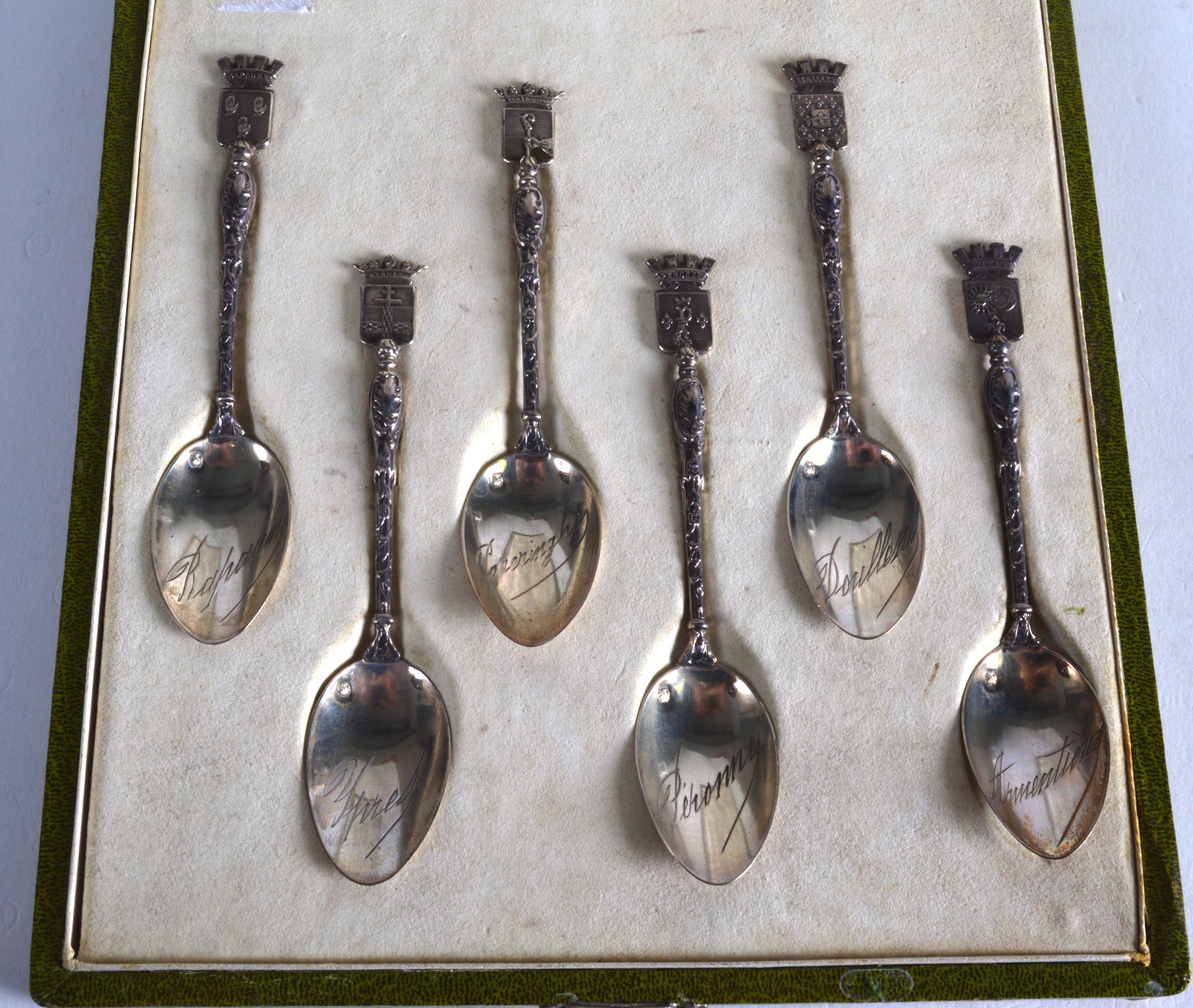 A CASED SET OF EARLY 20TH CENTURY FRENCH SILVER SPOONS each inscribed with a town.