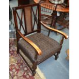 A REGENCY DESIGN BERGERE ARMCHAIR with pierced lattice work back plate and upholstery. (2)