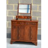 A REPRODUCTION MAHOGANY CABINET together with a cylindrical hammered brass stick stand. Cabinet