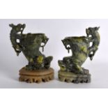 A PAIR OF LATE 19TH/20TH CENTURY CHINESE CARVED HARDSTONE LIBATION CUPS upon soapstone bases. 7.