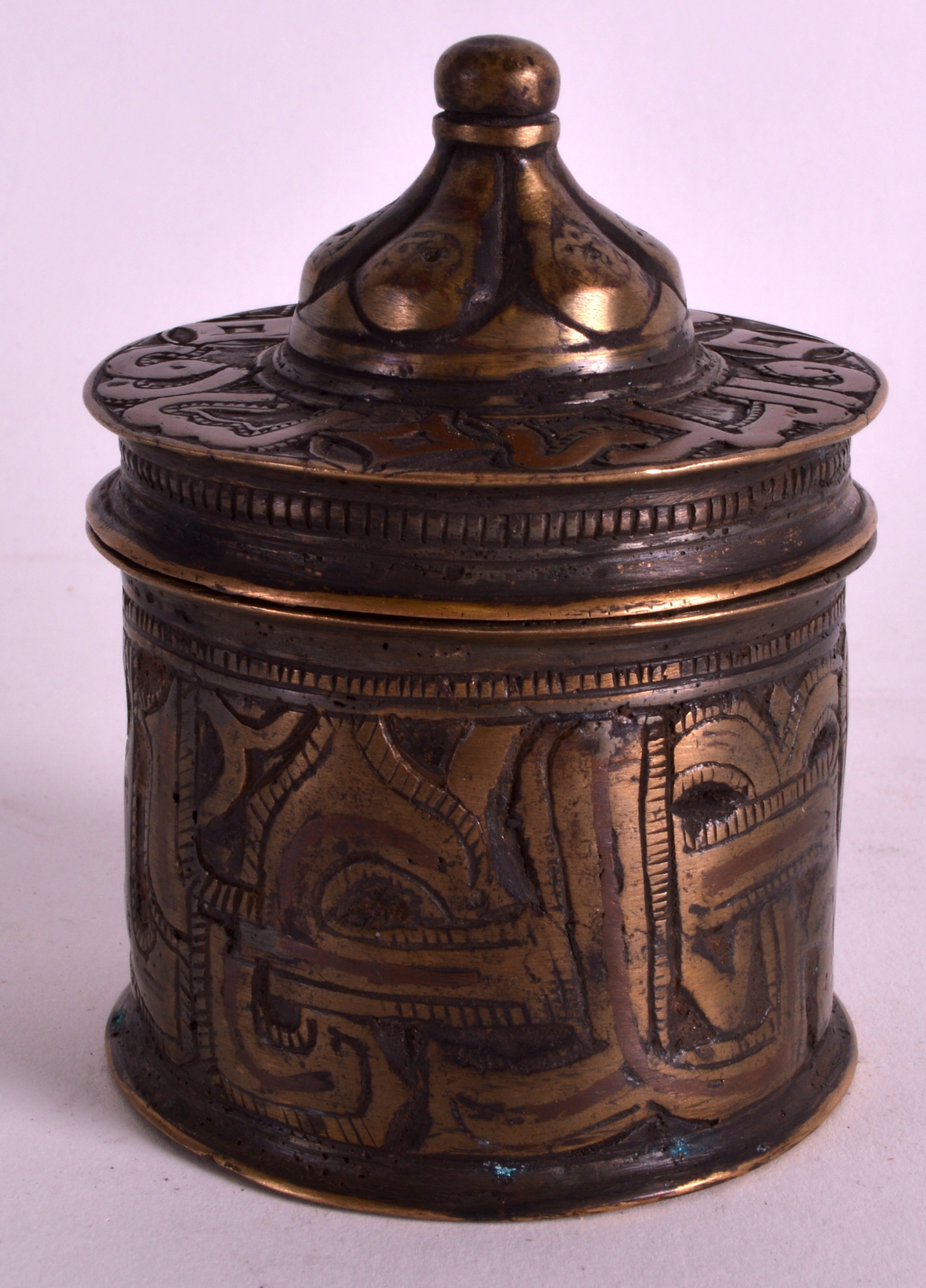 A 13TH/14TH CENTURY PERSIAN BRONZE INKWELL with removable top, decorated all over with Kufic script.