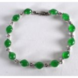 AN EARLY 20TH CENTURY CHINESE WHITE METAL AND JADE BRACELET of good colour.