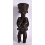 AN UNUSUAL EARLY 20TH CENTURY AFRICAN HARDWOOD FERTILITY FIGURE modelled with a child breast