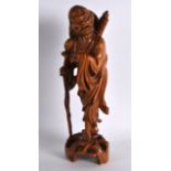 A 19TH CENTURY CHINESE CARVED HARDWOOD FIGURE OF AN IMMORTAL modelled holding a bat upon a