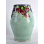 A STYLISH RADFORD POTTERY VASE painted with stylised red and purple flowers. 7.75ins high.