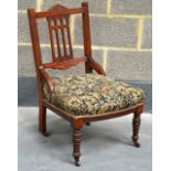 A VICTORIAN MAHOGANY NURSING CHAIR.