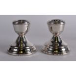 A SMALL PAIR OF MODERN SILVER CANDLESTICKS. 2.5ins high.