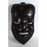 A HEAVY AFRICAN CARVED HARDWOOD MASK OF A MALE. 1Ft 3ins x 9.5ins.