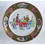 A 19TH CENTURY CHINESE CANTON FAMILLE ROSE PLATE painted with figures within an interior. 10Ins