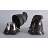 A PAIR OF NOVELTY SILVER PLATED INKWELLS in the form of a Victorian firemans helmet. 4Ins high. (2)