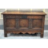 A GOOD 18TH CENTURY RECTANGULAR OAK COFFER with carved floral decoration and internal candle box.