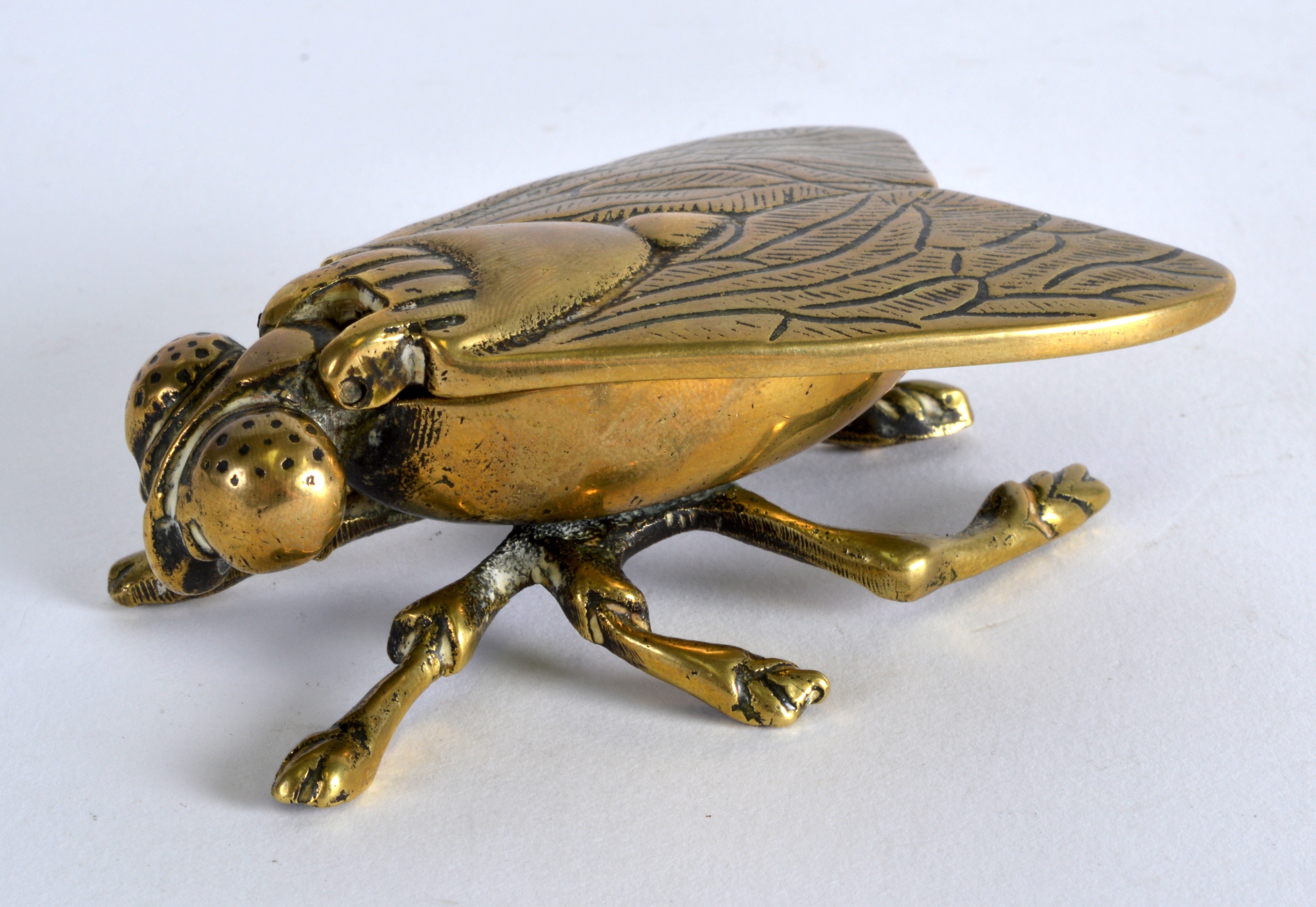 AN EARLY 20TH CENTURY BRASS INKWELL in the form of a fly. 4Ins wide.