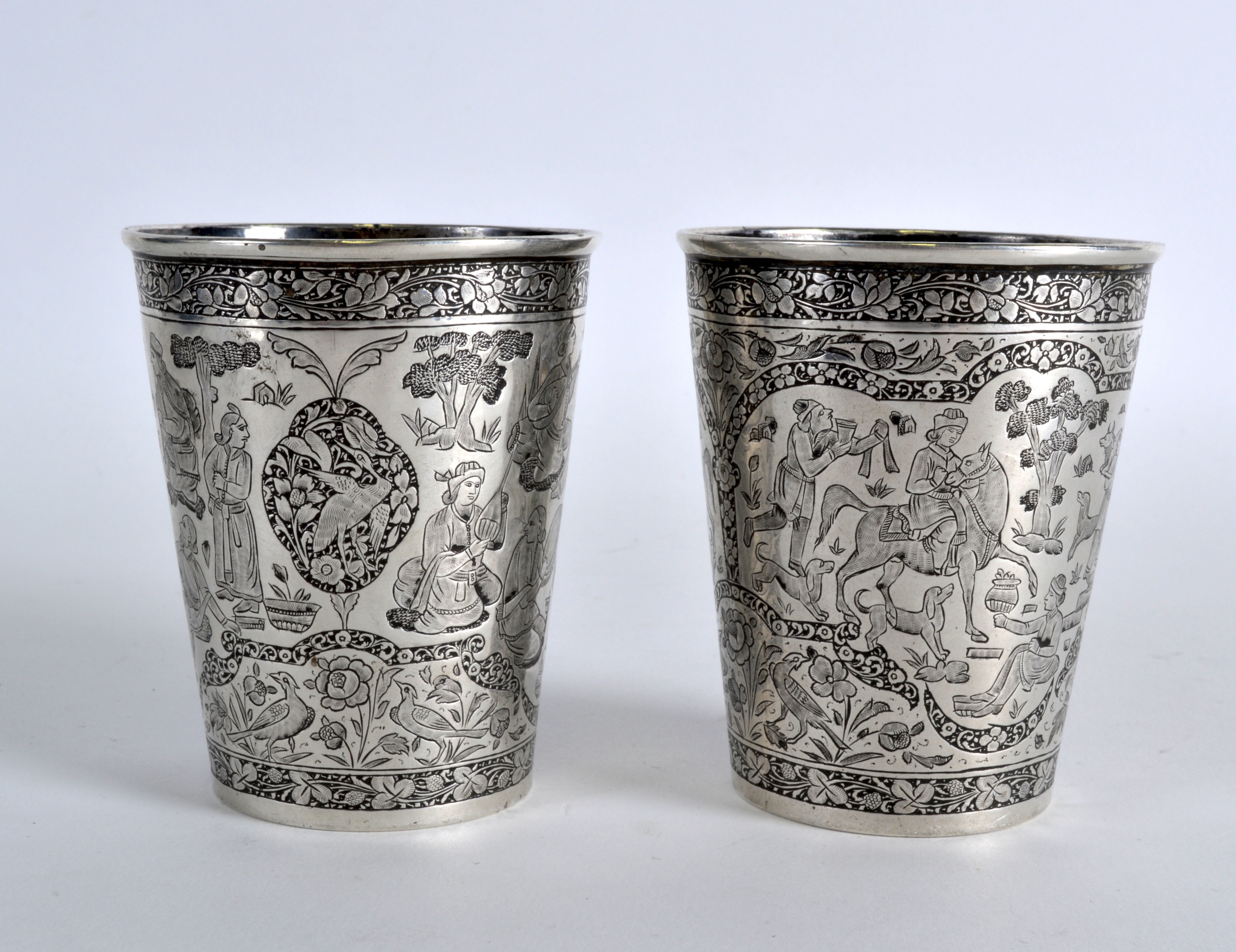 A FINE PAIR OF EARLY 19TH CENTURY INDIAN SILVER BEAKERS well decorated all over with figures,