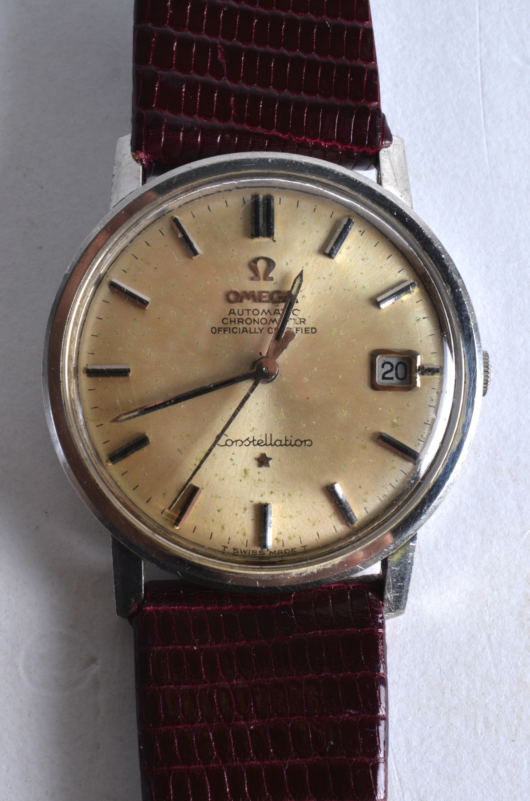 A 1970S OMEGA AUTOMATIC CHRONOMETER CONSTELLATION WRISTWATCH with red leather strap. 1.25ins