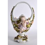 A LATE 19TH CENTURY NYMPHERNBURG PORCELAIN BASKET surmounted with winged cherubs, encrusted with