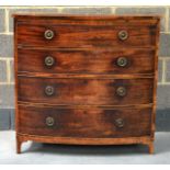 A REGENCY MAHOGANY BOW FRONT CHEST OF DRAWERS with brushing slide, over four drawers upon splayed