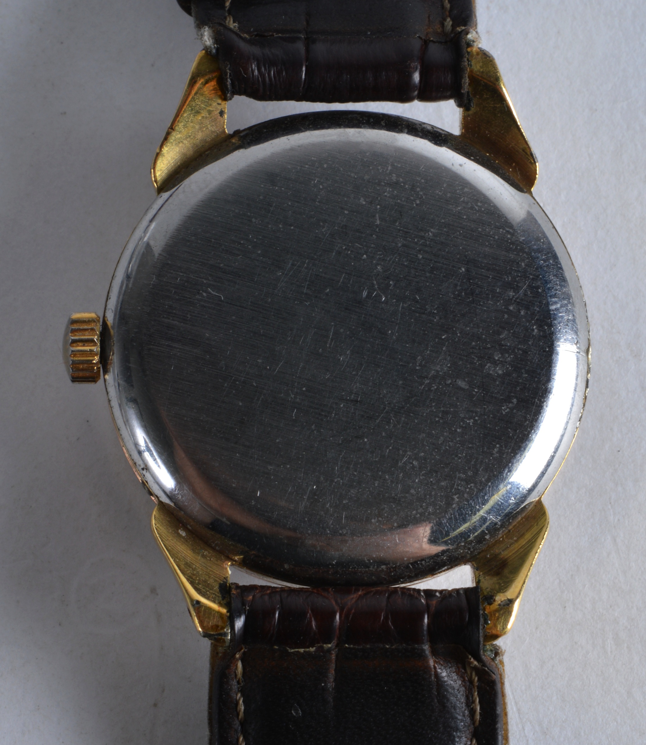 A 1950S GENTLEMANS MOVADO YELLOW METAL GENTLEMANS WRISTWATCH with brown leather strap. 1.5ins - Image 2 of 2