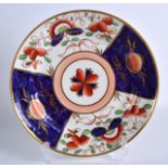 AN UNUSUAL EARLY 19TH CENTURY SWANSEA PORCELAIN PLATE painted in imari tones with flowers. 8.25ins