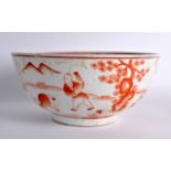 A CHINESE IRON RED GLAZED BOWL 20th Century, bearing Qianlong marks to base, decorated with figures.