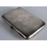 AN EDWARDIAN HAMMERED SILVER CALLING CARD CASE C1920 with central monogram. 4.25ins wide.