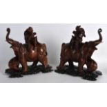 A PAIR OF LATE 19TH CENTURY CHINESE CARVED HARDWOOD ELEPHANTS modelled with attendants upon there